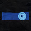 A royal blue stretch hairband with a light blue button detail against a black background.