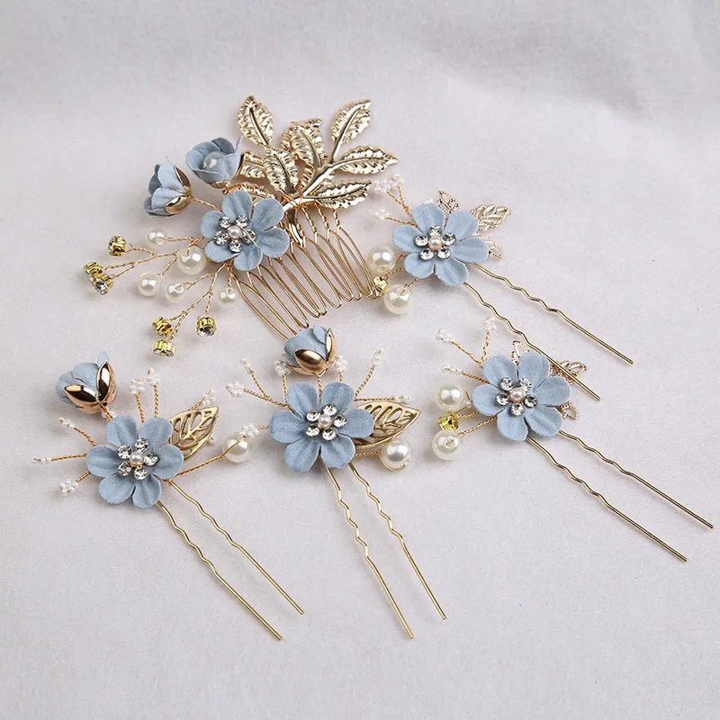 A set of five floral pearl bridal hair accessories featuring light blue flowers and gold accents.