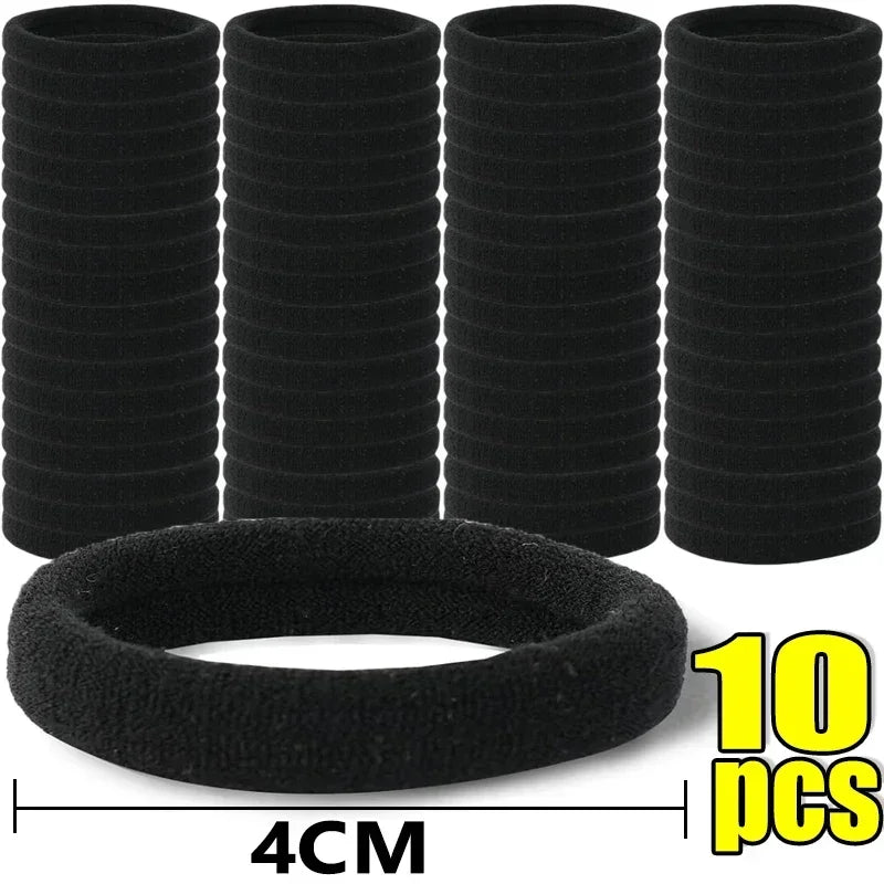 Ten black elastic hair bands stacked and one laid out, measuring 4cm wide.
