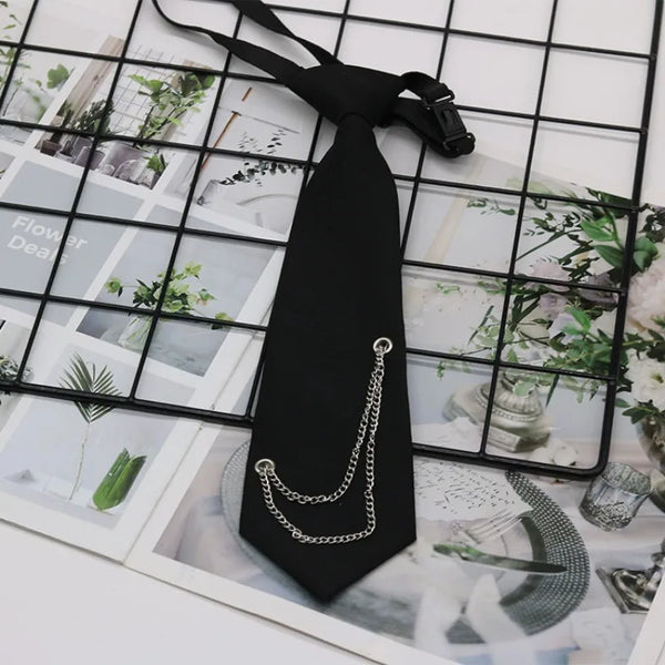 Black classic chain necktie accessory with a silver chain detail displayed on a grid background.