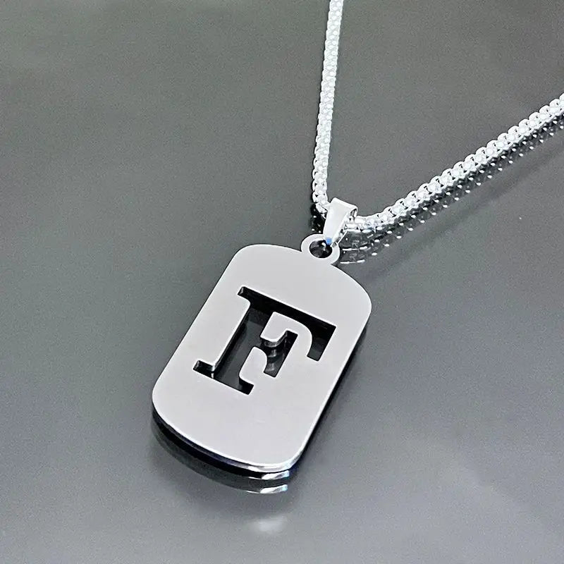 A silver stainless steel pendant necklace featuring a large initial letter F on a chain.