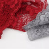 A close-up of a red floral lace hair headband and a gray floral lace hair headband.