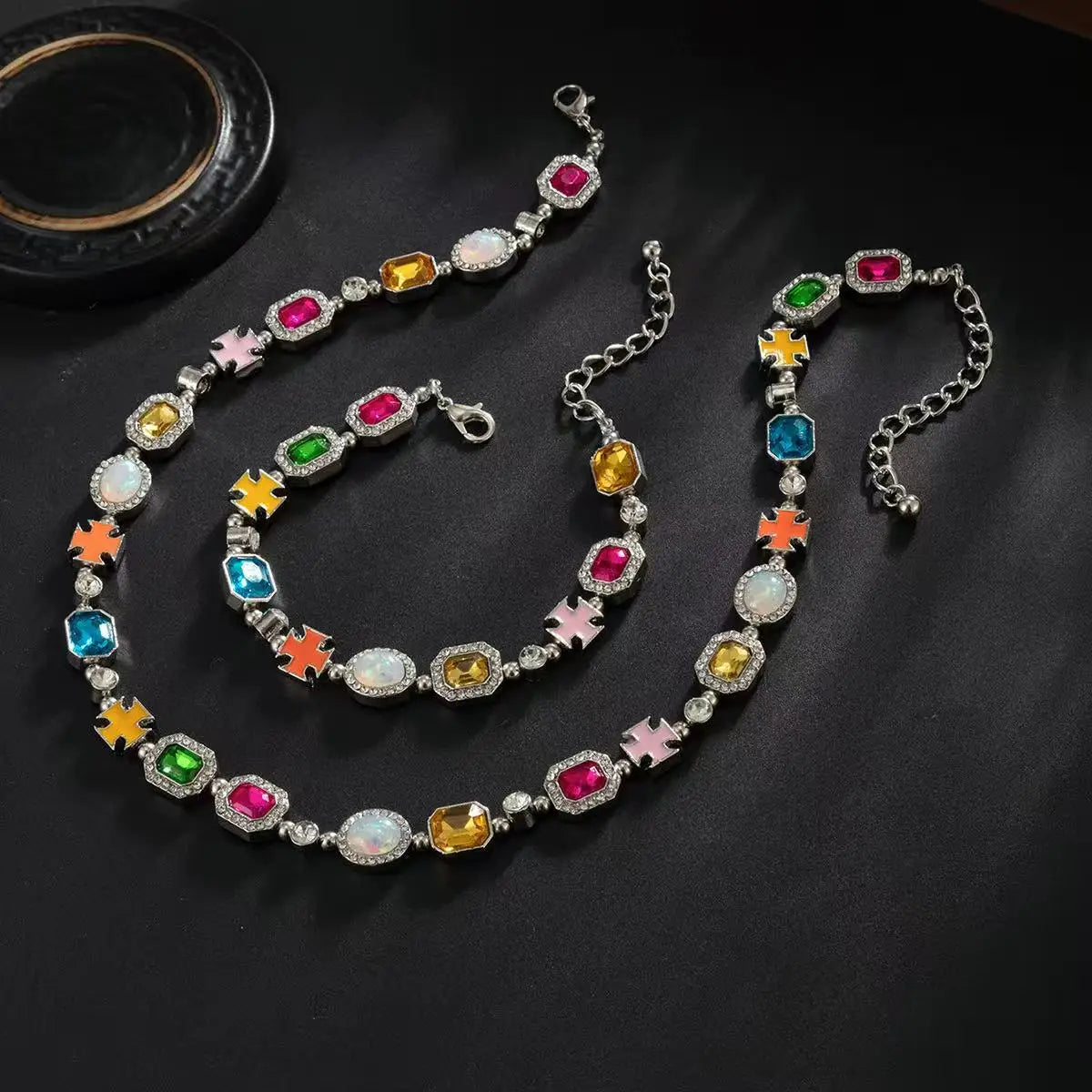 A multi-color enamel tennis chain necklace featuring various colored gemstones and accents.