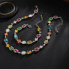 A multi-color enamel tennis chain necklace featuring various colored gemstones and accents.