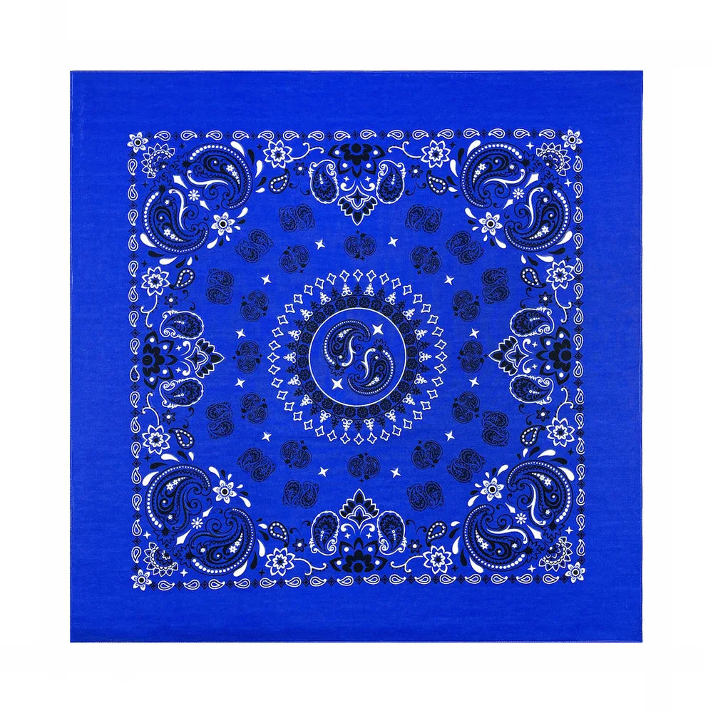 A vibrant blue fabric with intricate white paisley and floral patterns printed on it.