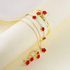 A set of five gold-toned bracelets featuring red enamel plum blossoms displayed on a white background.