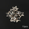 A pile of silver star-shaped metal snap hair clips.