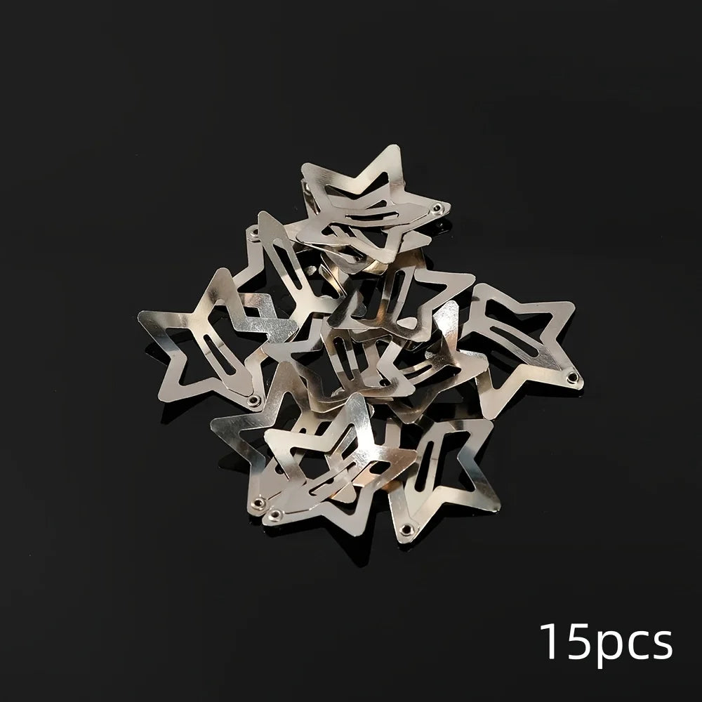 A pile of silver star-shaped metal snap hair clips.