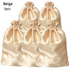 Five beige satin drawstring storage bags for hair tools
