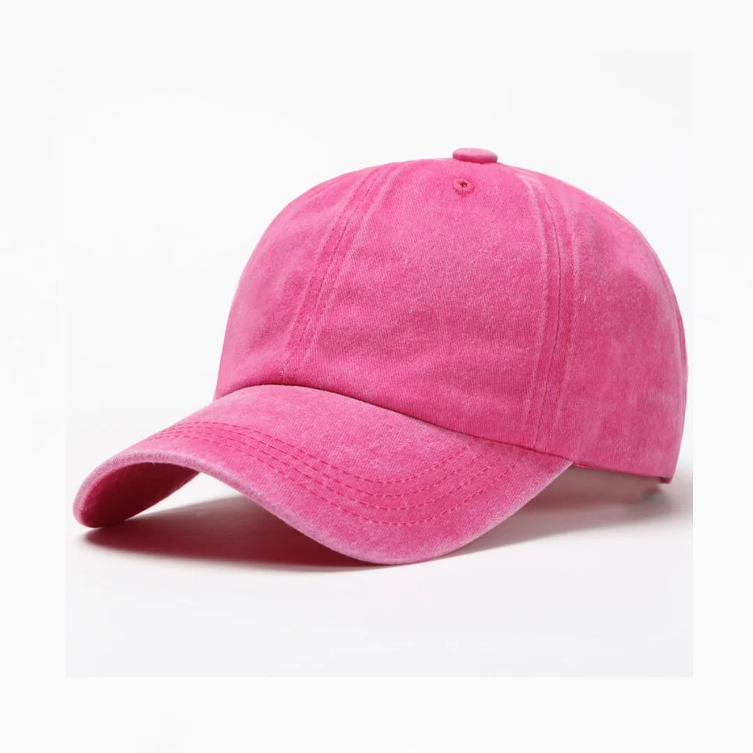 A pink washed cotton snapback cap shown from the side.