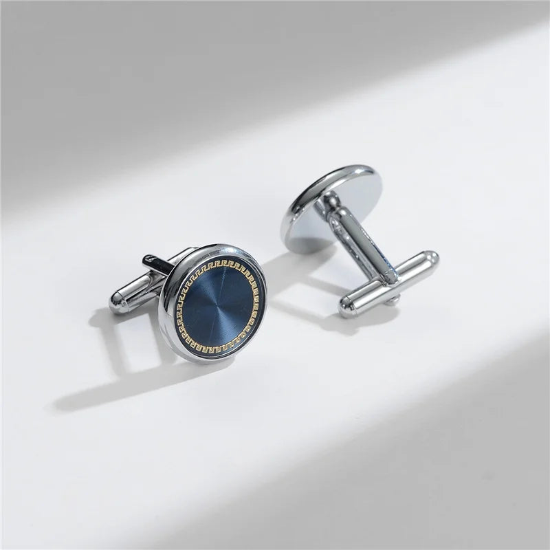 A pair of elegant silver cufflinks with a dark blue enamel design and a textured finish.