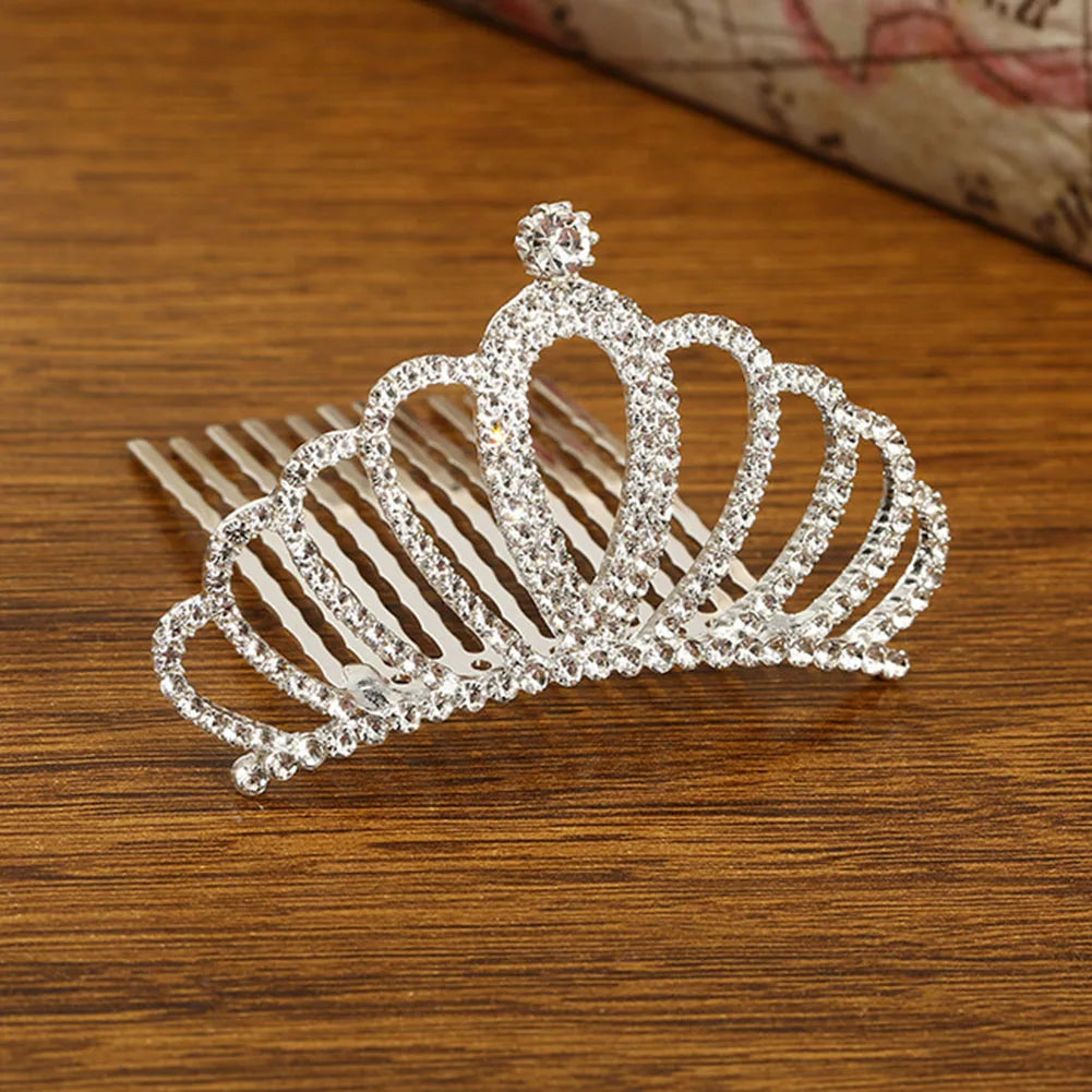 Sparkling crystal princess tiara hair comb for women displayed on a wooden surface.
