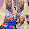 A model wearing a blonde straight HD lace front wig with an orange and blue floral patterned shirt.