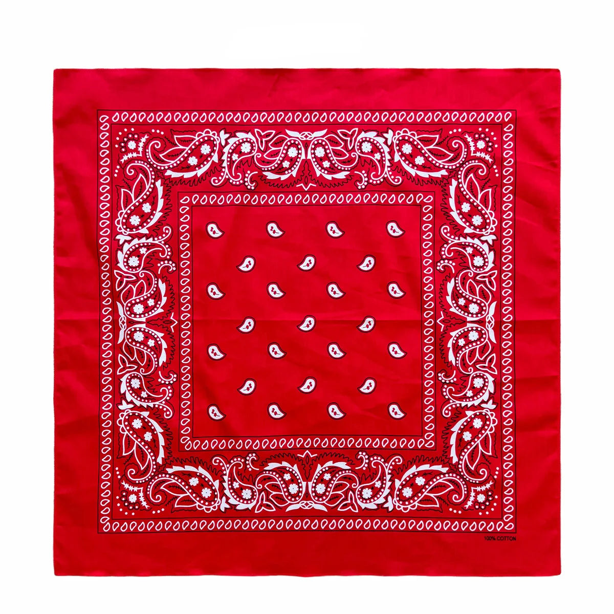 A red fabric with white paisley embroidery forming a square pattern inside a decorative border.