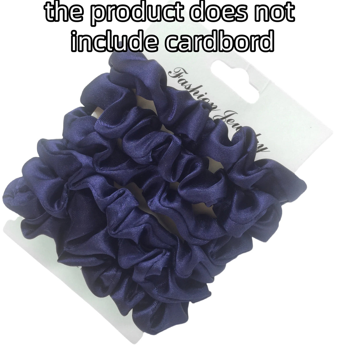 A pile of dark purple satin hair scrunchies displayed on a white card.