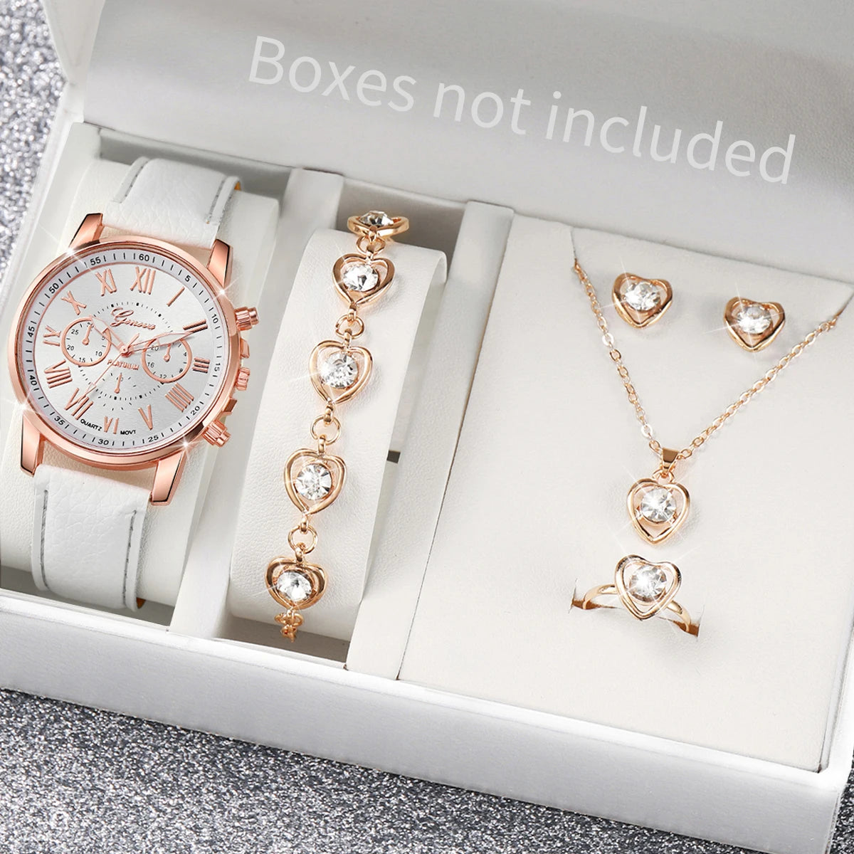 A box contains a rose gold fashion quartz wristwatch with a leather strap, a gold necklace, and a ring.