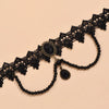 Black lace choker necklace featuring a large black oval gemstone and dangling black beads