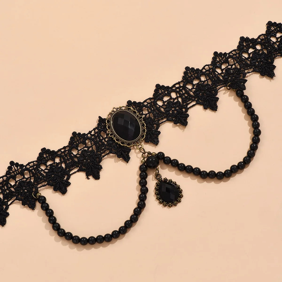 Black lace choker necklace featuring a large black oval gemstone and dangling black beads