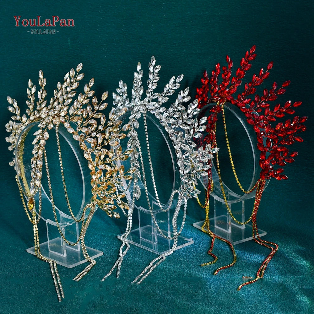 A display of handmade rhinestone bridal crown headbands in gold, silver, and red on clear stands.