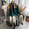 A draped luxury plaid cashmere feel scarf and shawl wrap in shades of green, beige, and olive.
