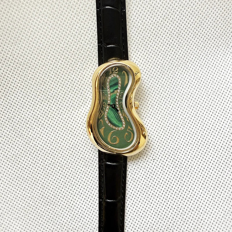 A vintage irregular quartz watch with a gold-toned bezel and green dial is shown on a black leather strap.
