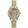 A gold-toned quartz watch with a clear crystal face and a full bezel of small rhinestones on the band.