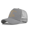 A gray adjustable baseball cap with a gold embroidered logo featuring the text STONE RANCH.