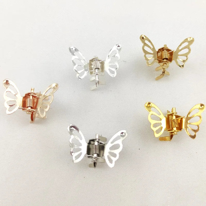 A collection of ten mini hollow butterfly metal hair clips in gold and silver tones.