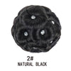 A black synthetic curly hair bun clip-in hairpiece with several clear crystals embedded in the hair.