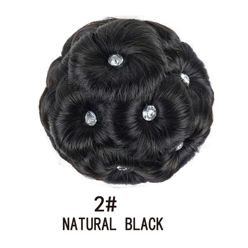 A black synthetic curly hair bun clip-in hairpiece with several clear crystals embedded in the hair.