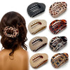 A set of leopard print matte oval hair claw clips in various shades and finishes.
