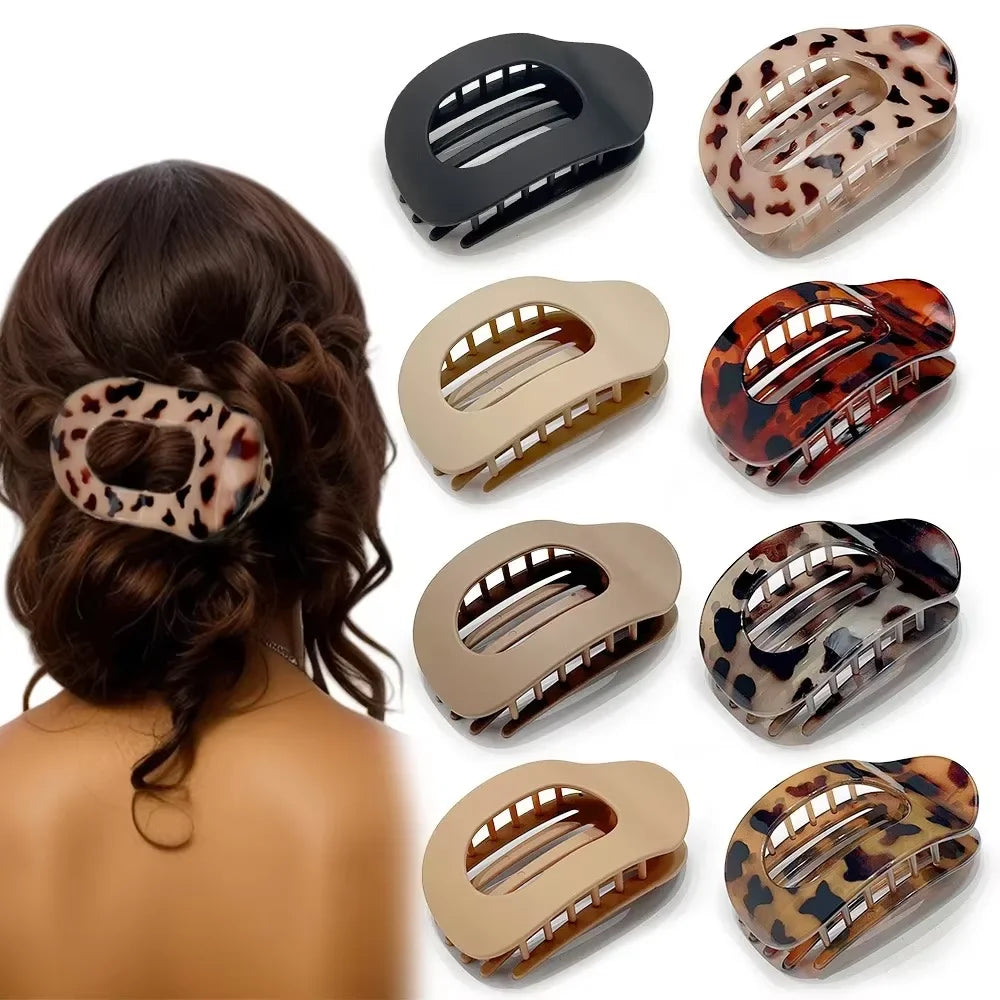 A set of leopard print matte oval hair claw clips in various shades and finishes.