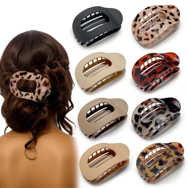 A set of leopard print matte oval hair claw clips in various shades and finishes.