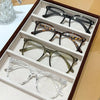 A set of classic square anti-blue light eyewear displayed in an open box with various frames.