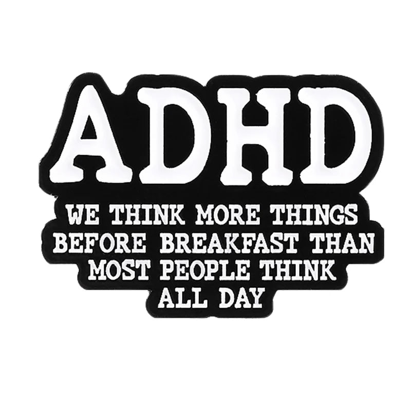 Black and white enamel lapel pin featuring the text ADHD and a related phrase.