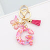 Alphabet letter G acrylic keychain with pink butterfly charm and tassel