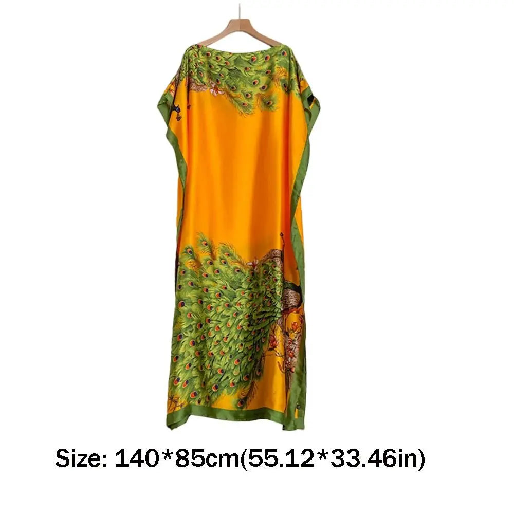 Orange and green floral butterfly peacock cape shawl displayed on a hanger