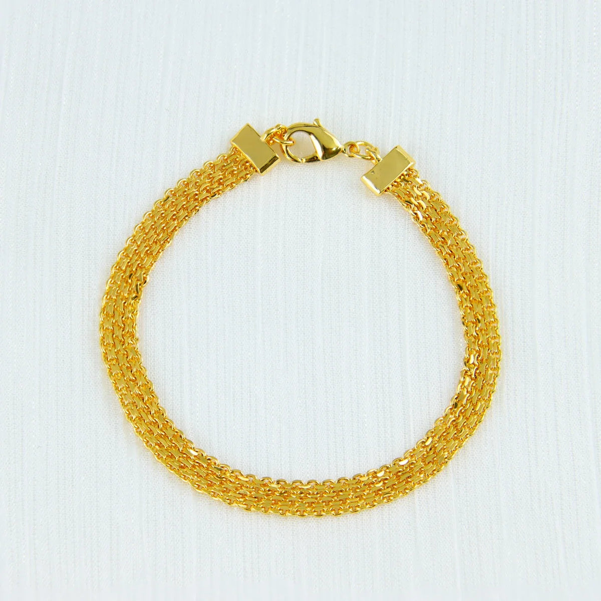 A gold-plated necklace set featuring a chain and a pendant, displayed against a white background.