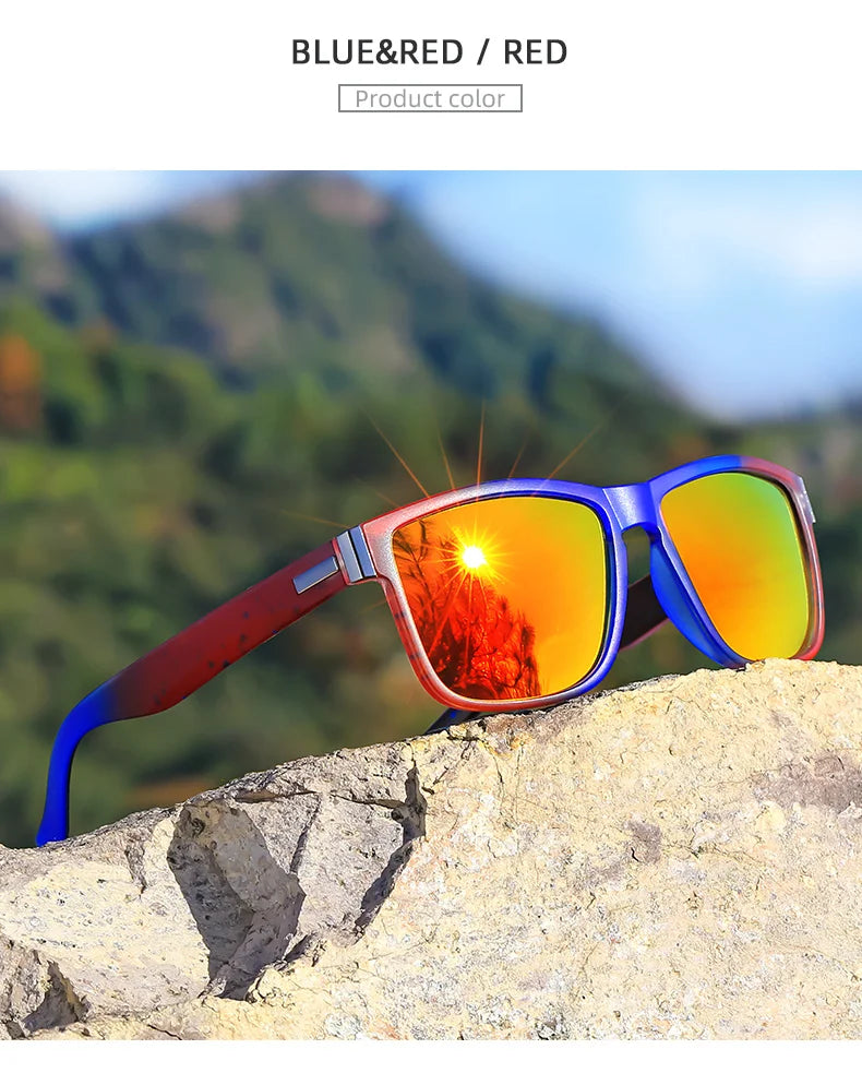 Blue and red gradient polarized sunglasses resting on a rocky surface with a blurred green mountain background.