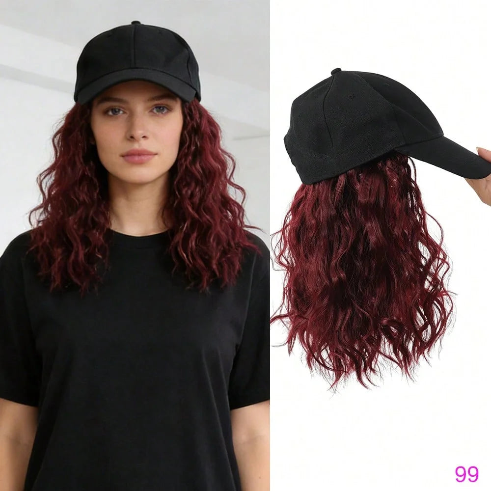 A model wearing a black t-shirt and a black adjustable short wave wig with long red curls.