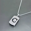 A silver stainless steel pendant necklace featuring a large letter C on a chain.