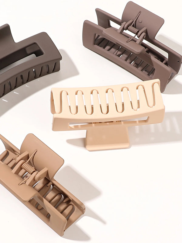 A set of seven square hair claw clips in a matte beige color shown from various angles.