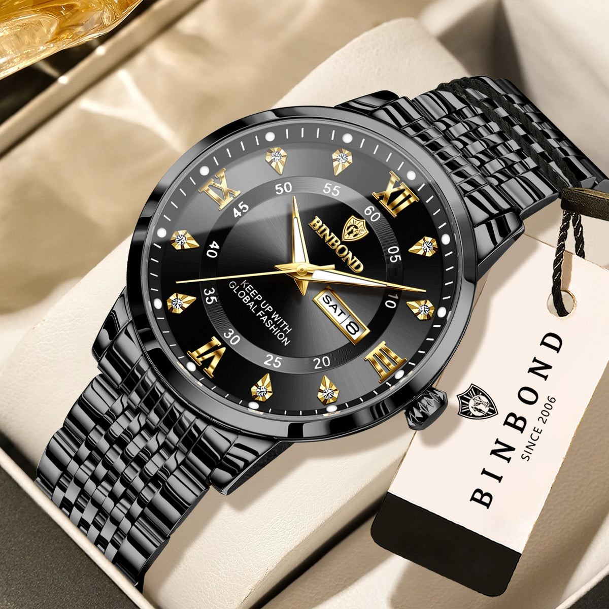 A black fibond wrist watch with a dark face and gold accents is displayed on a light background.
