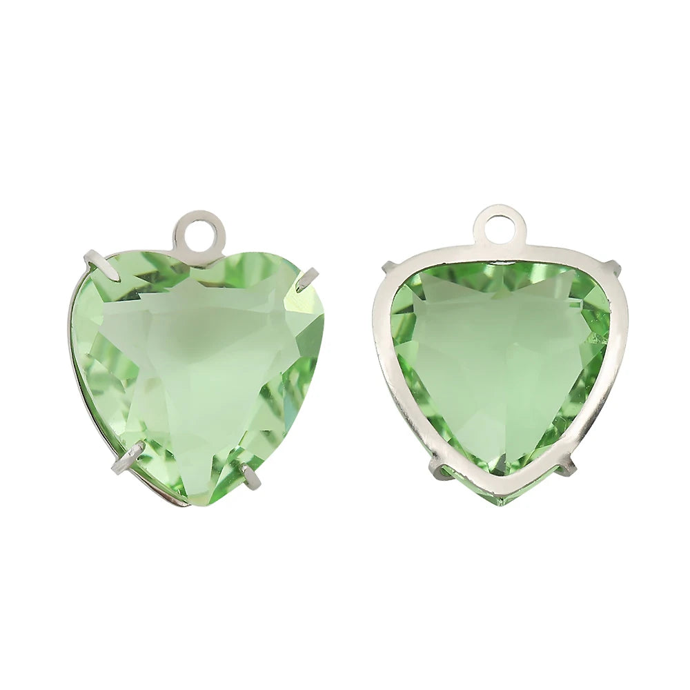A pair of heart-shaped crystal pendants with a light green hue set in stainless steel.