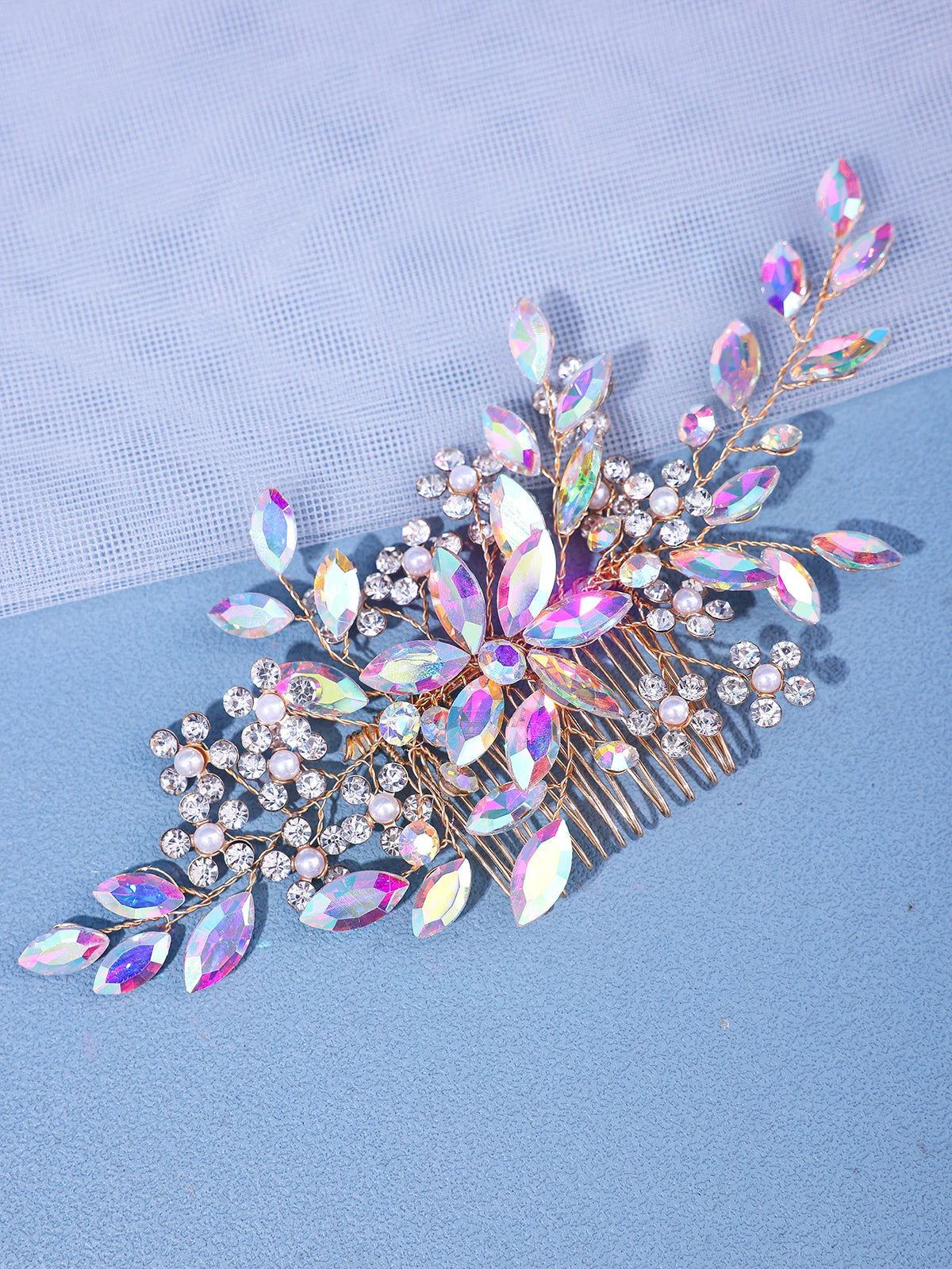 A delicate crystal pearl hair comb and headband accessory featuring iridescent pink and purple floral elements.