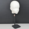 A white professional mannequin head displayed on a black stand for practice and display.