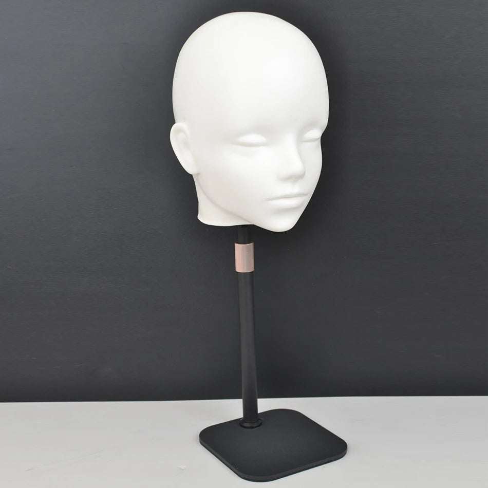 A white professional mannequin head displayed on a black stand for practice and display.
