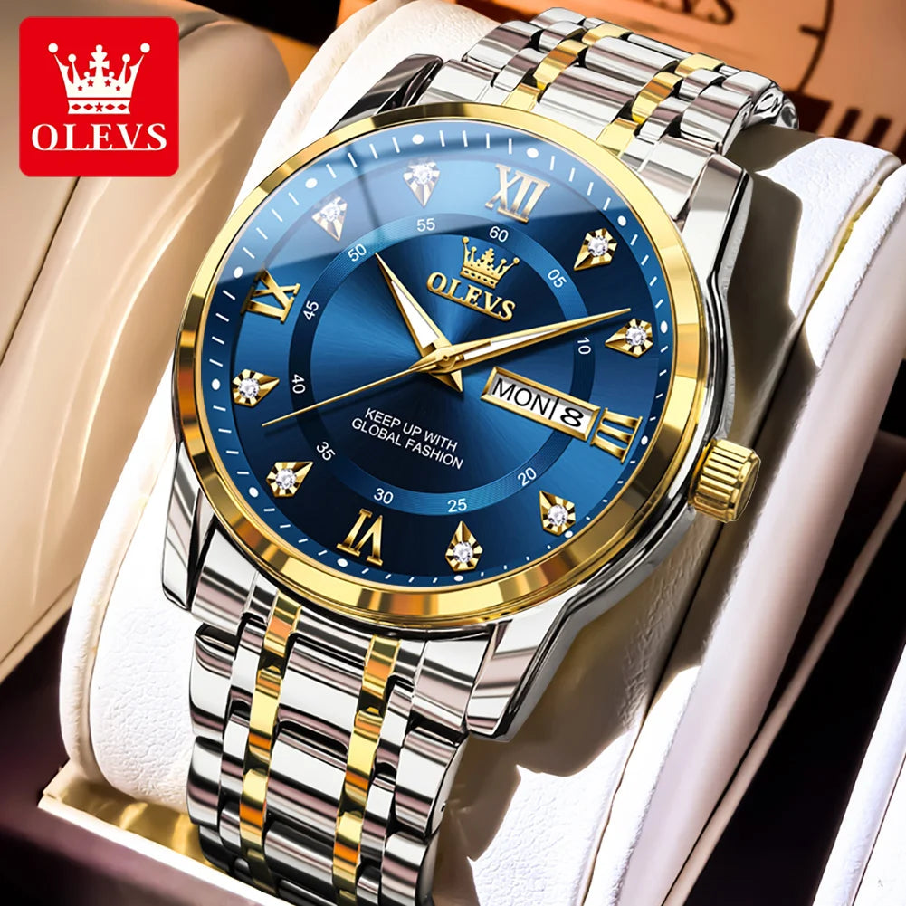 A gold-toned OLEVS watch with a blue dial and silver bracelet displayed in a white box.