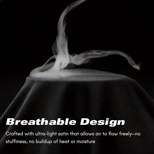 A black satin fabric is shown with wisps of steam rising from it, demonstrating breathable design.