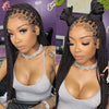 A close-up photo of a woman modeling a 36 inch full lace box braids wig with intricate parting and gold jewelry.